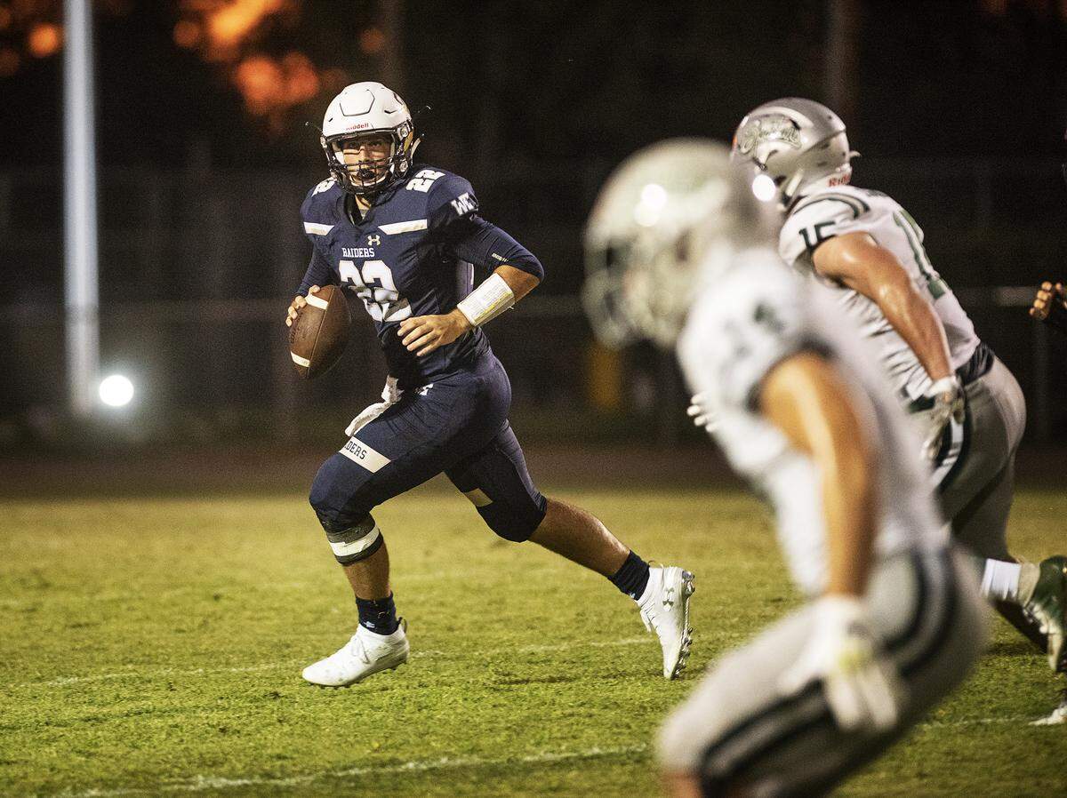 Central Catholic’s Dalton Durossette rolls out to pass during the non-league game with De La Salle at Central Catholic High School in Modesto, Calif., Aug. 30, 2019.