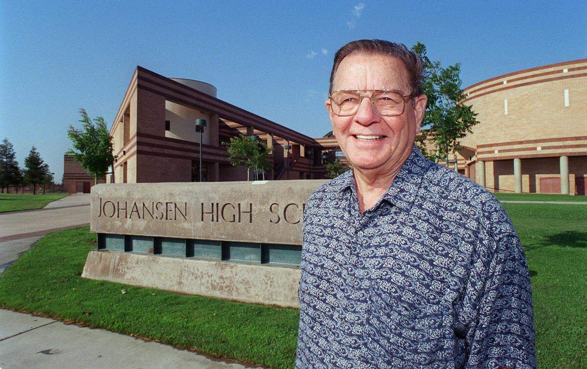 Peter Johansen, near the Johansen High School sign.