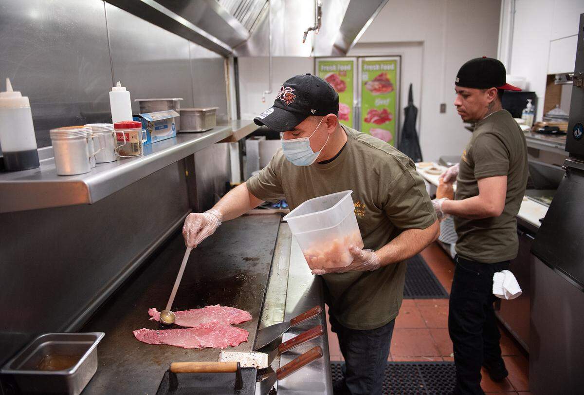 Saul Gonzalez, left, and Jorge Perez cook at Lupita’s Home Style Cocina on Oakdale Road in Modesto, Calif., on Thursday, Jan. 27, 2022.