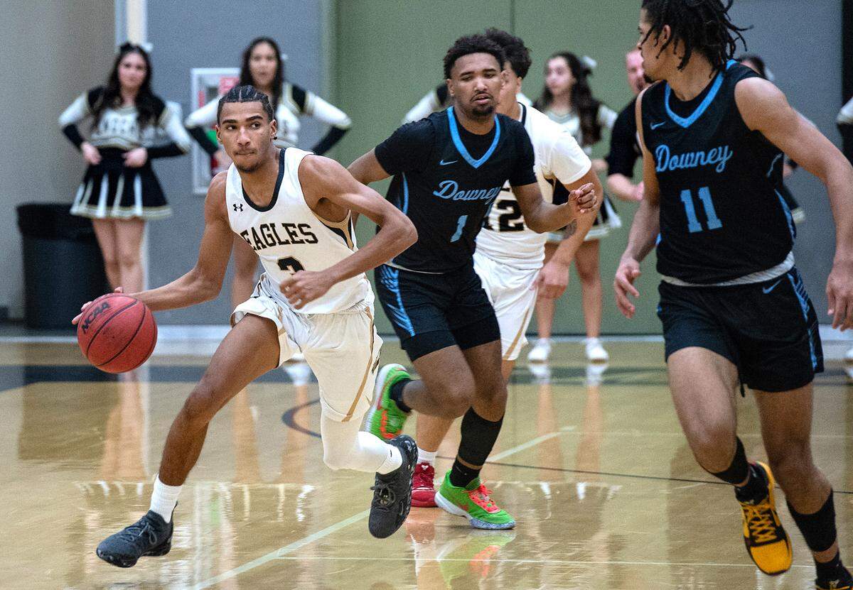 Enochs’ Kevin King advances the ball during the Central California Athletic League game with Downey at Enochs High School in Modesto, Calif., Friday, Jan. 27, 2023. Downey won the game 47-40.