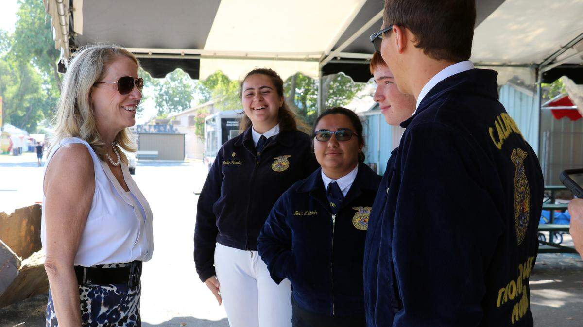 New Modesto City Schools Superintendent Sara Noguchi talks with FFA members at the Stanislaus County Fair on Friday, July 20, 2018.