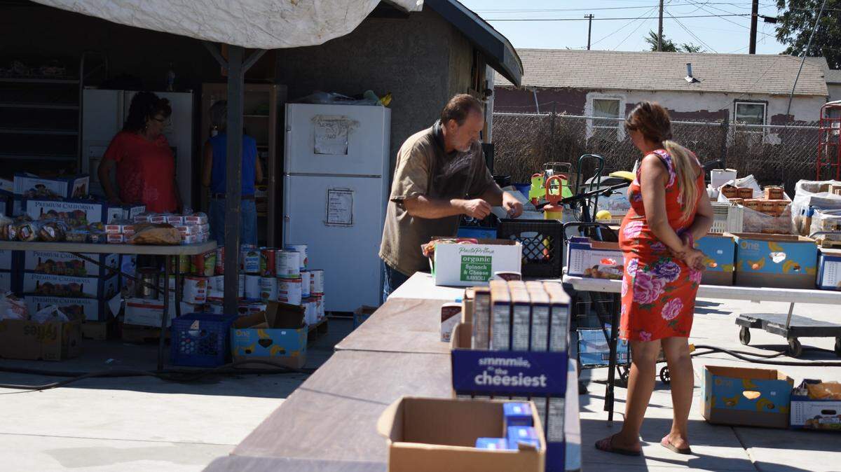 Griselda Madriz Pulido, 32, is helped at the Rock Church food pantry in Modesto.