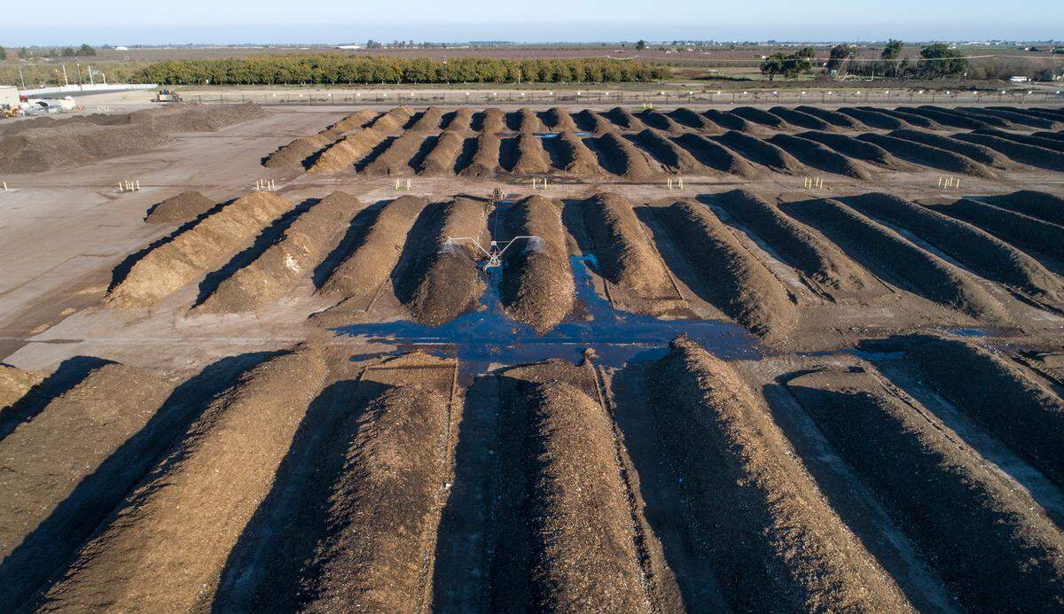 Rows of organic material breaks down as part of the composting process at the City of Modesto Compost Facility west of Modesto, Calif., on Wednesday, Nov. 17, 2021.