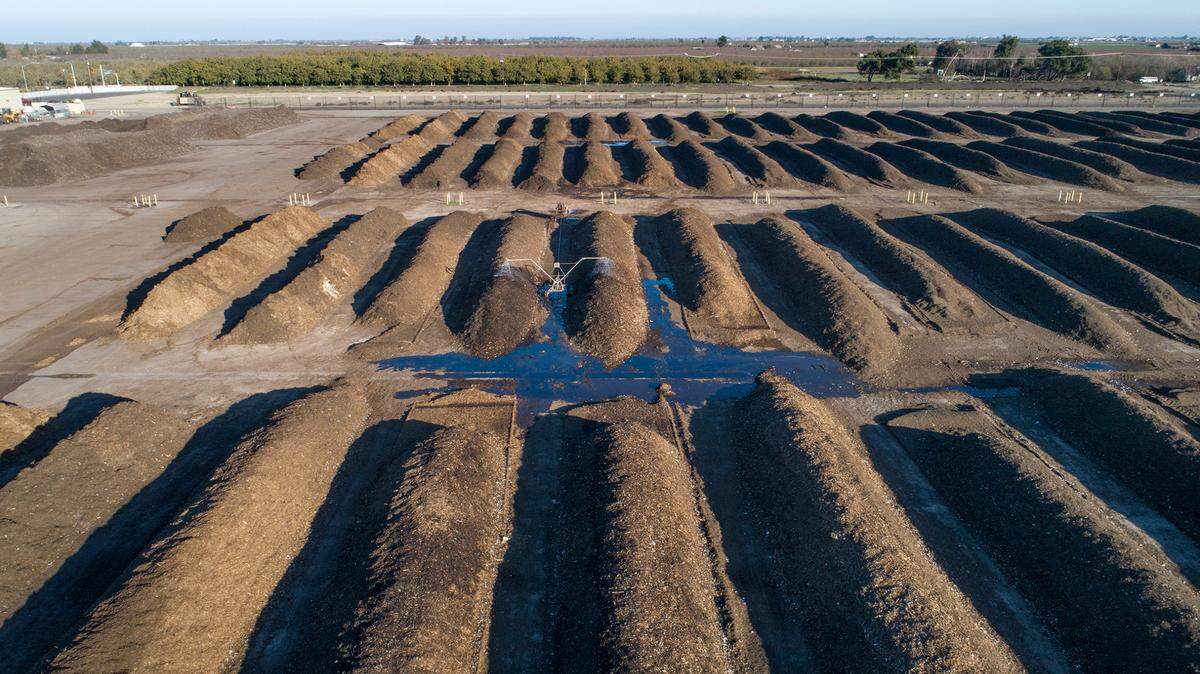 Rows of organic material breaks down at a composting facility near Modesto.