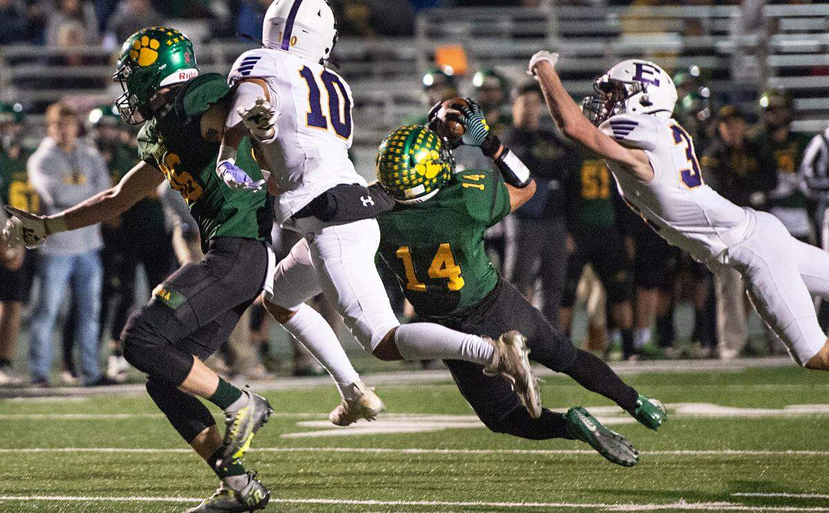 Sonora’s Bryce Nicolson (14) makes a catch falling backwards during the Sac-Joaquin Section Division V championship game with Escalon at St. Mary’s High School in Stockton, Calif., Saturday, Nov. 26, 2022.