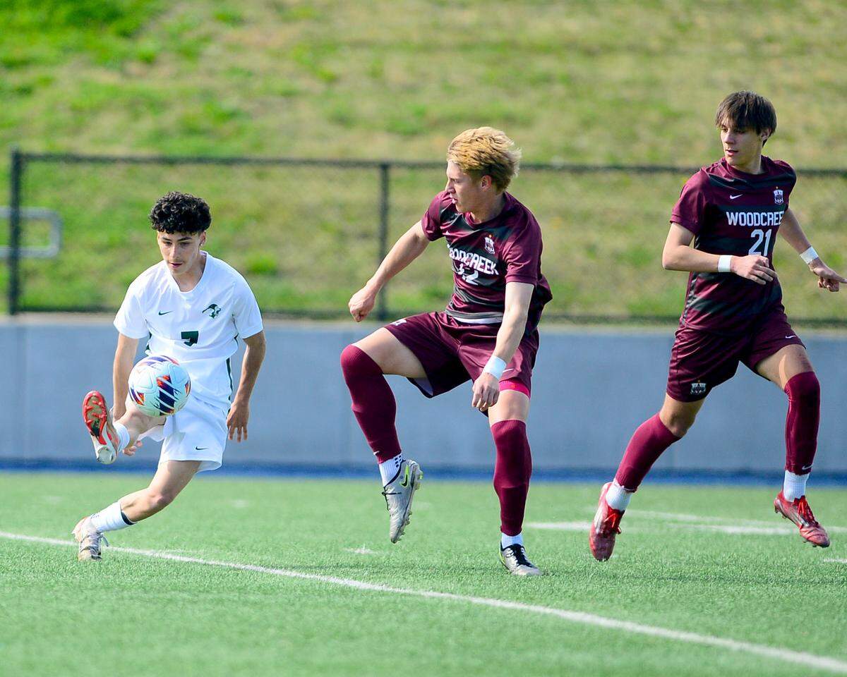 Pitman’s Giancarlo Nakamura (7) controls the ball near two defenders during the Sac-Joaquin Section Division II championship against Woodcreek High School at Cosumnes River College in Sacramento, Calif. on Saturday, March 1, 2025.