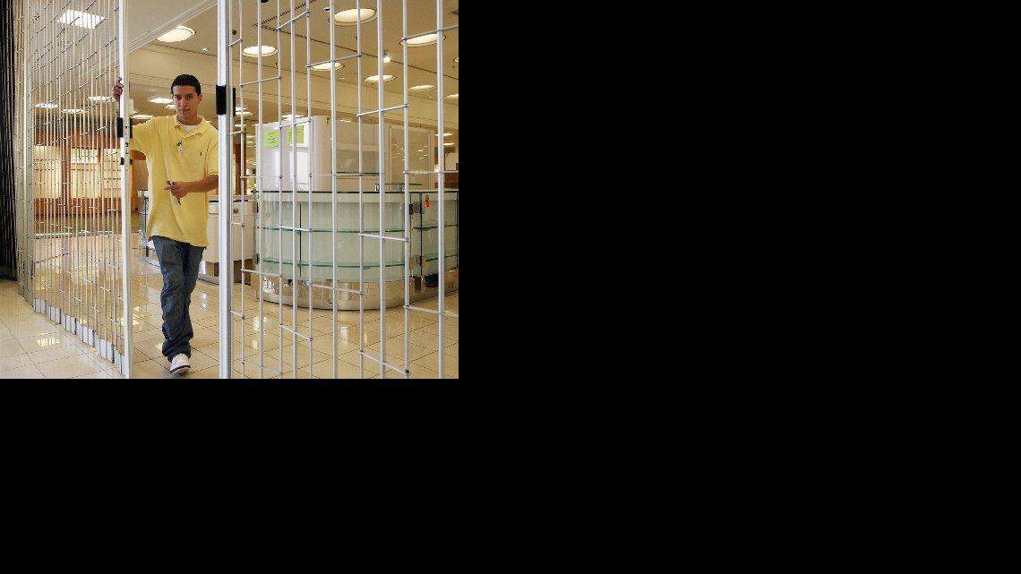 Ramiro Luevano Jr. closes the gate at the Fashion Fair Gottschalks in Fresno for the last time as the store shuts down for good Sunday, July 12, 2009. The Fashion Fair location will now become a Forever 21 clothing store, as will the old Gottschalks space at the Vintage Faire Mall in Modesto. (CRAIG KOHLRUSS/THE FRESNO BEE)