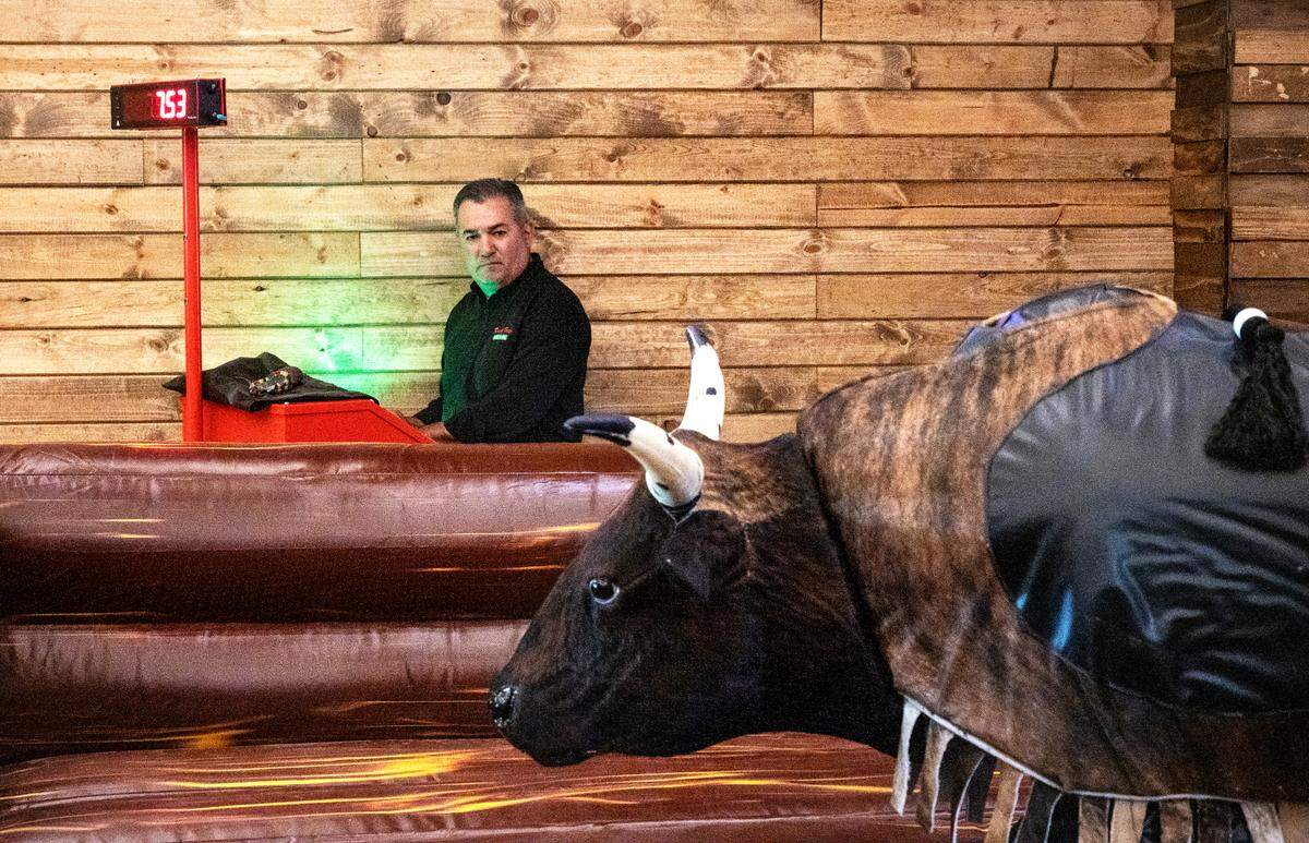 Owner Ismael Covarrubias starts up the mechanical bull at the soon to be opened Rancho Fresco Cantina and Nightclub in Modesto, Calif., on Friday, Oct. 1, 2021.