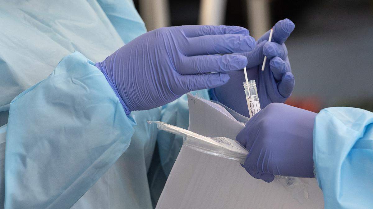 A nasal sample is collected from a client at the drive-up COVID-19 test site in Salida, Calif., on Tuesday, Nov. 10, 2020.