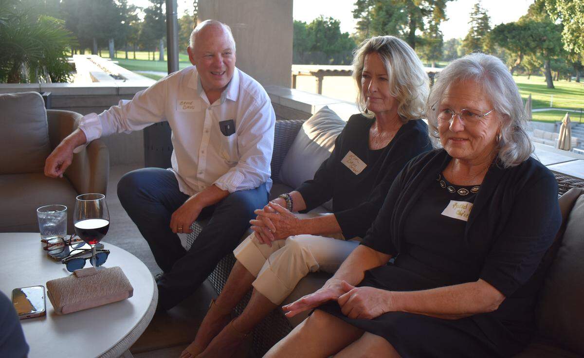 Husband and wife Bruce and Kim Davis reminisce with lifelong friend Rachel Strickler at the Beyer High School Class of 1975’s 50-year reunion at Del Rio Country Club north of Modesto on Saturday, Sept. 13, 2025.