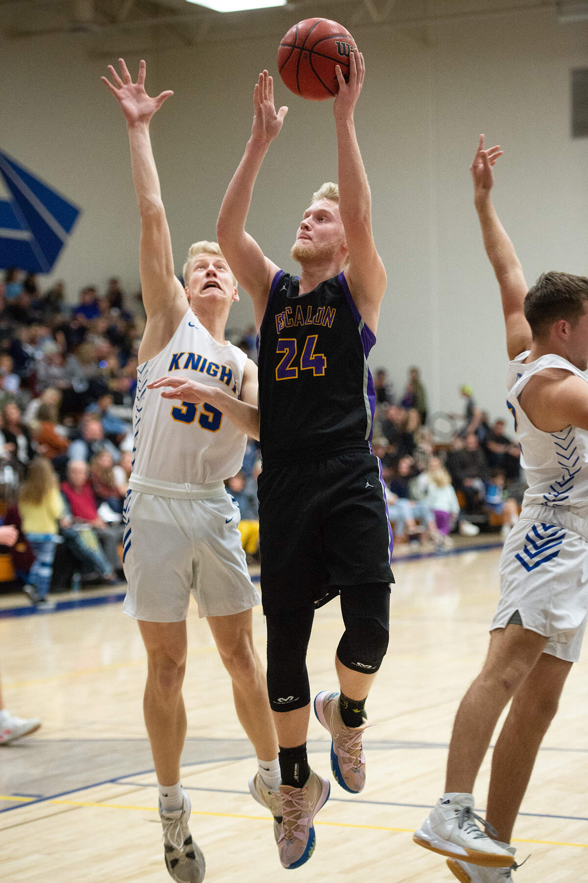 Escalon’s Russell Weinbrecht scores a basket past Ripon Christian’s Isaac Bos during the Trans Valley League game at Ripon Christian High School in Ripon, Calif., on Friday, Jan. 7, 2022. Ripon Christian won the game 61-53.