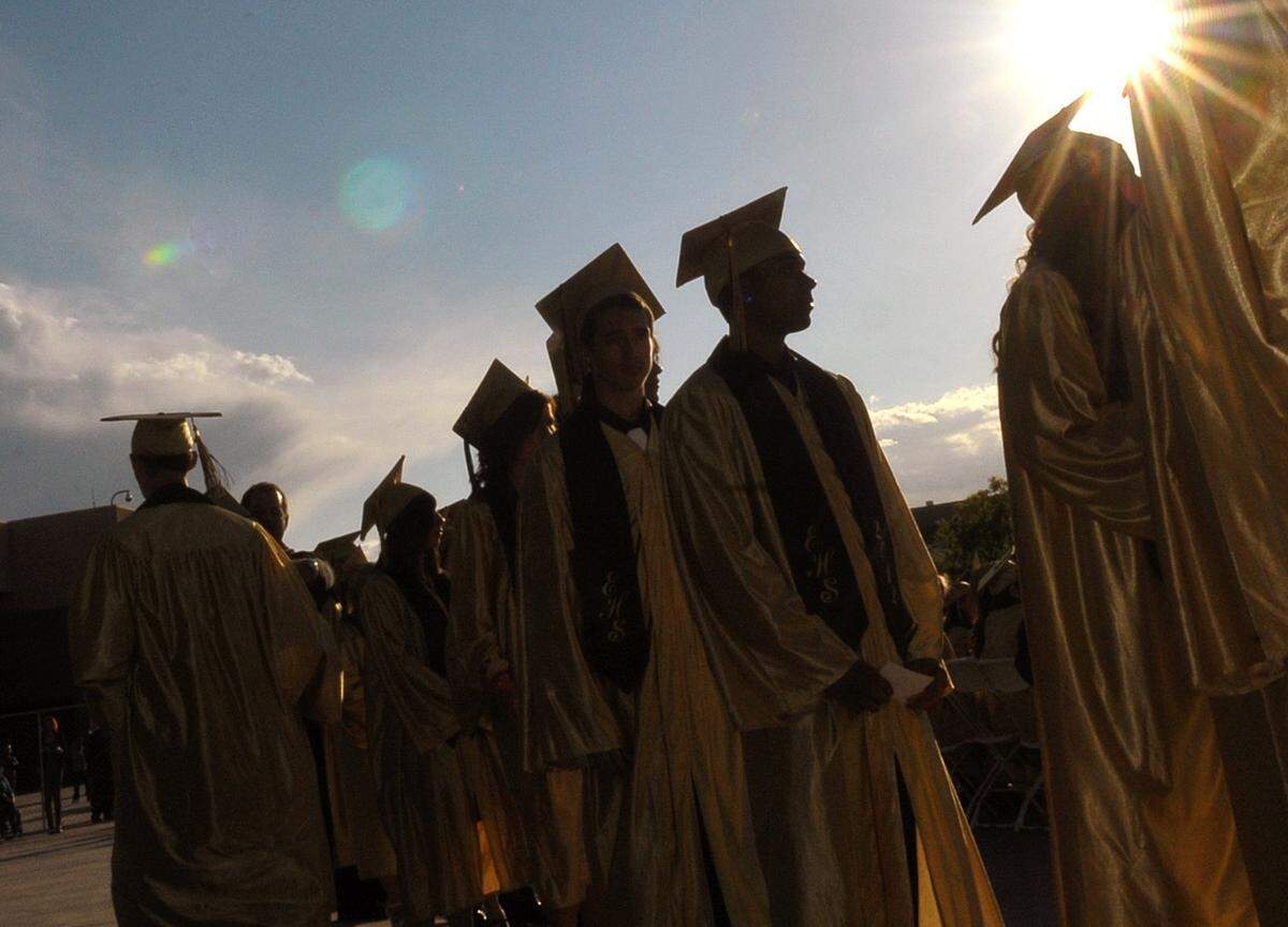 Enochs High School seniors wait to take the stage to receive their diplomas at a graduation ceremony in Modesto on Friday, May 25, 2012. 