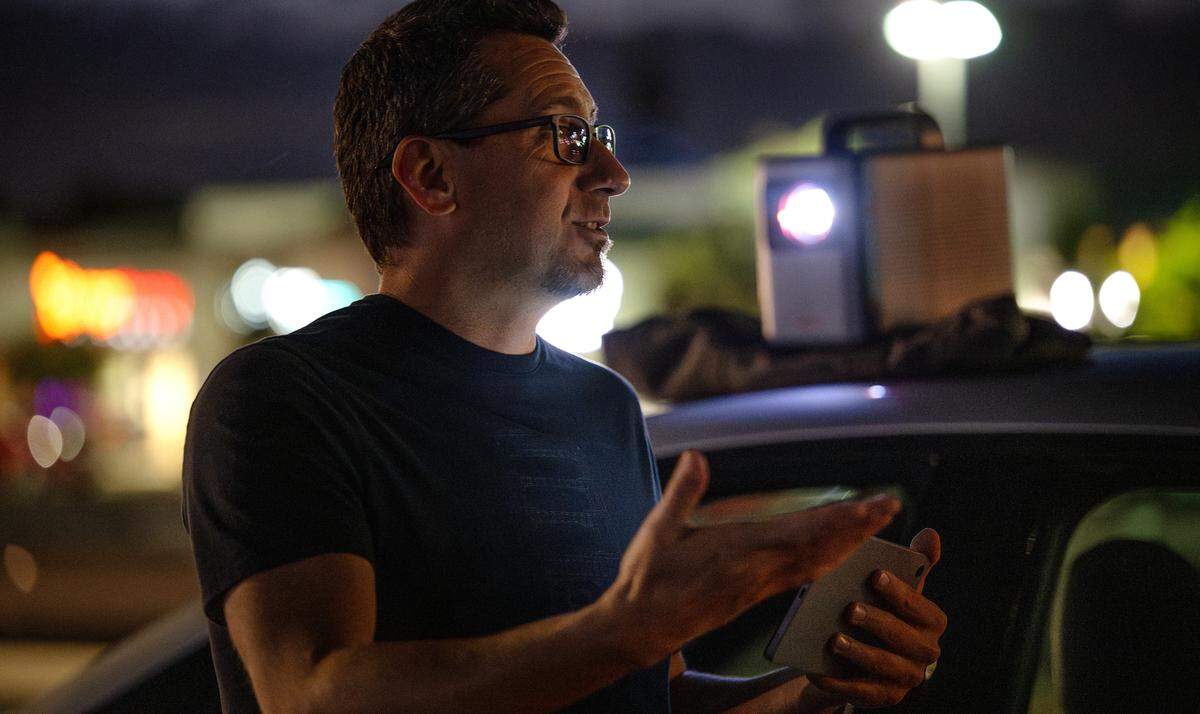 Local activists including Colby Zavala are projecting protest messages on the side of buildings as a form of silent visual protest in Modesto, Thursday, July 24, 2025.