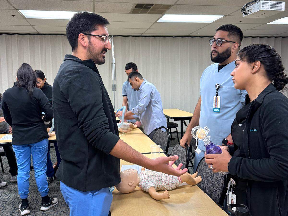 Rajman Randhawa, left, takes part in the internal medicine residency program at Memorial Medical Center.