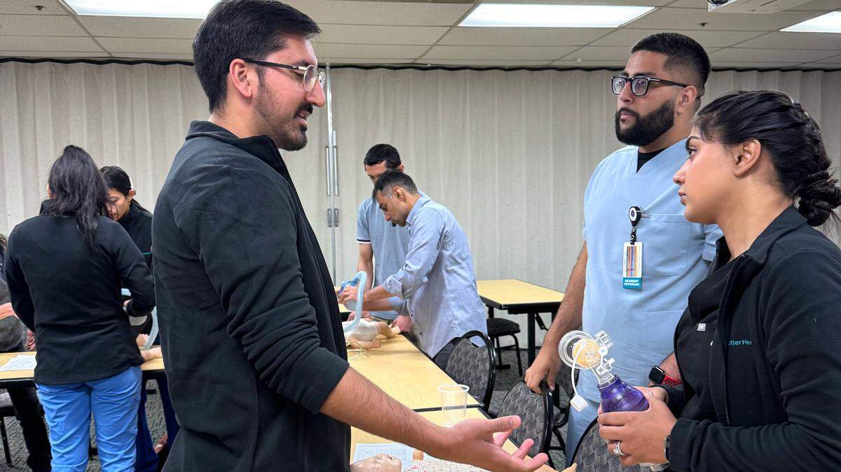 Rajman Randhawa, left, takes part in the internal medicine residency program at Memorial Medical Center.