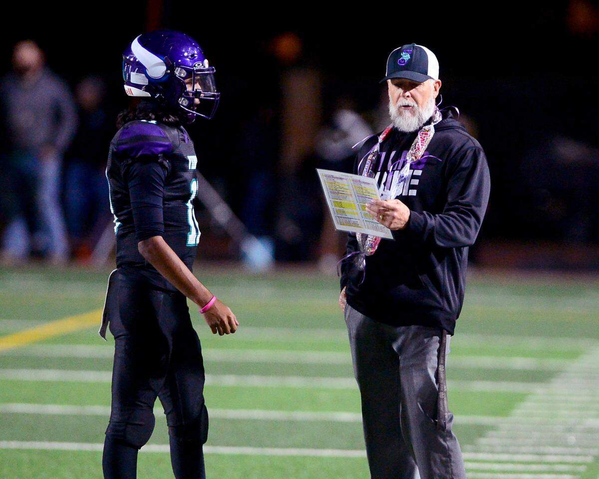 Johansen Head Coach Rod Smith Sr. tells Anthony Torres (11) a play during a game between Johansen and Davis at Johansen High School in Modesto California on November 1, 2024.