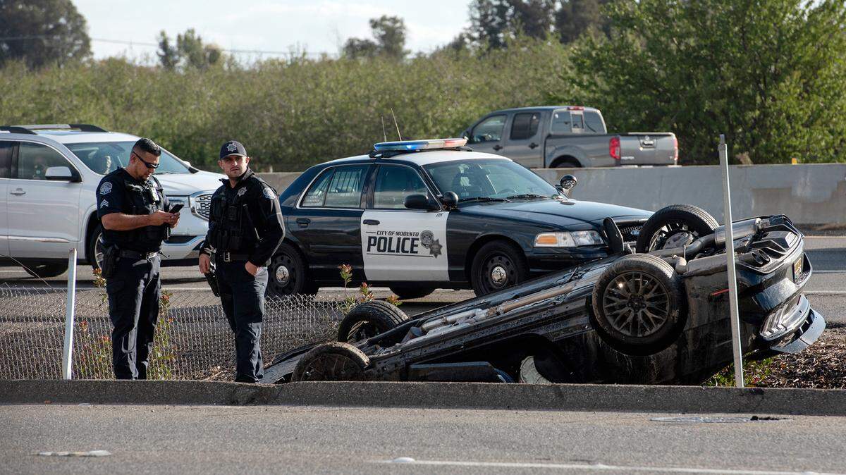 Modesto Police officers investigate a rollover crash on Sisk Road in Modesto, Calif., Monday, Oct. 25, 2021.