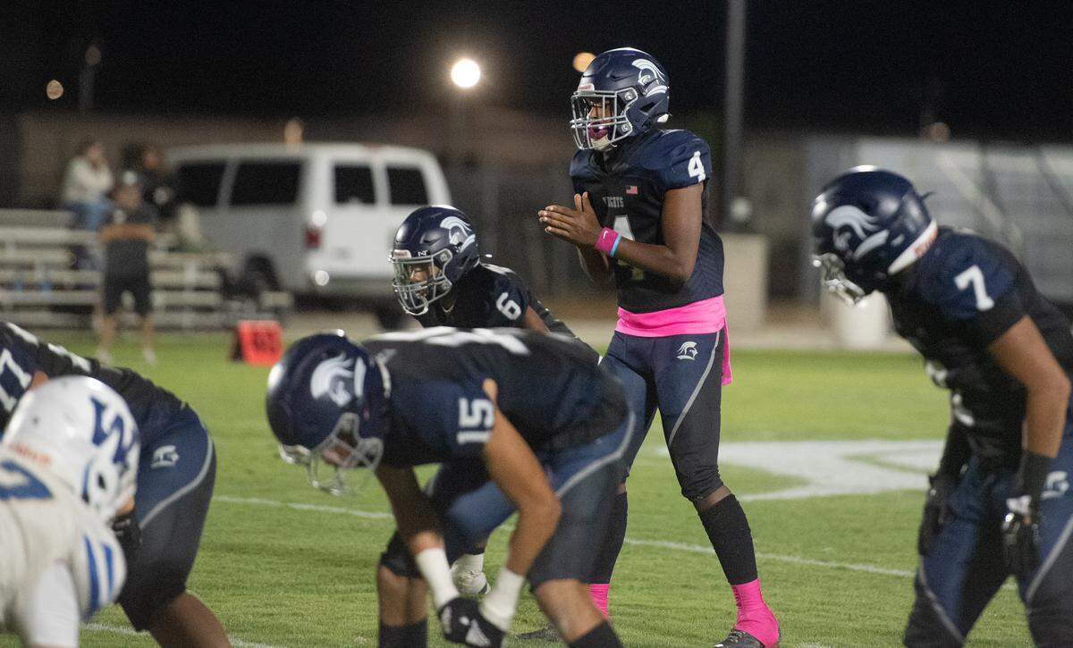 Stone Ridge Christian junior quarterback Marcus Gray prepares for a snap during the Knights’ 48-16 homecoming win over Waterford on Friday night in Merced. Gray threw four touchdown passes to lead the Knights to their second straight Southern League victory.