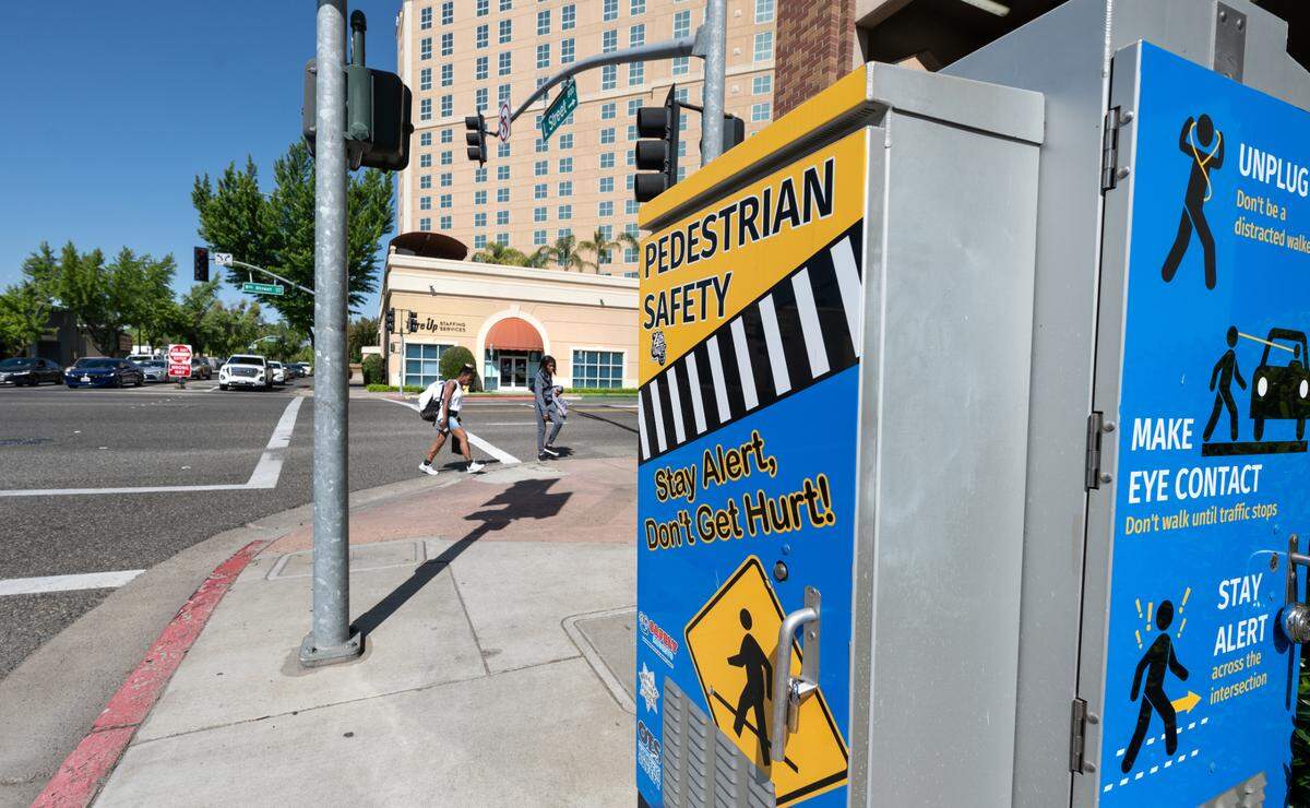 Pedestrians walk on 9th Street in Modesto.