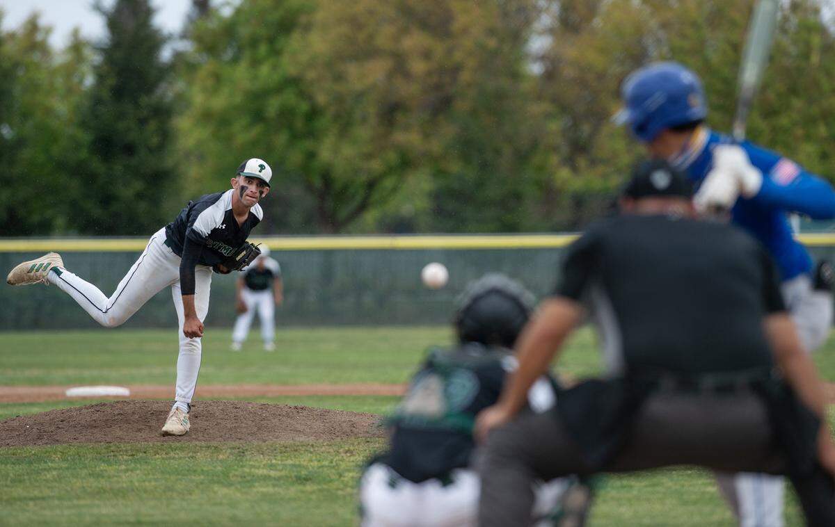 Pitman’s Mateo Garcia delivers a pitch during play in the Central California Athletic League game with Turlock at Pitman High School in Turlock, Calif., on Thursday, April 14, 2022.