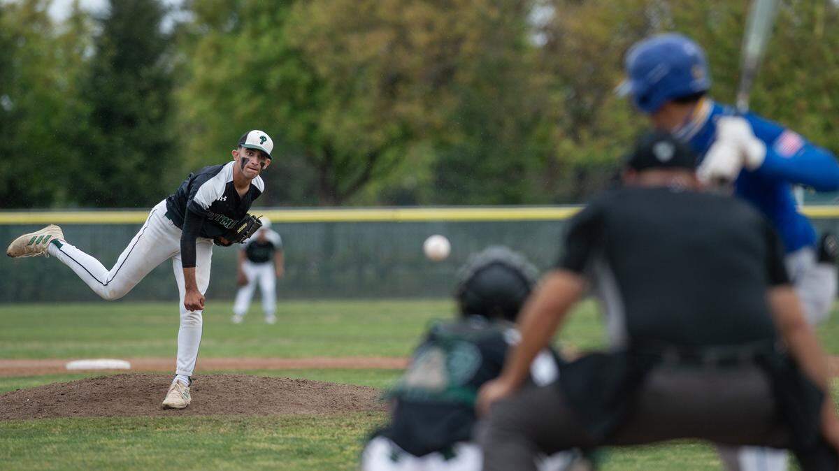 Pitman’s Mateo Garcia delivers a pitch during play in the Central California Athletic League game with Turlock at Pitman High School in Turlock, Calif., on Thursday, April 14, 2022.