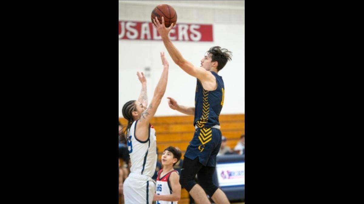 Gregori’s Kyle Monk scores over Beyer’s Gio Primofiore during the Holiday Hoop Classic at Modesto Christian High School in Salida, Calif., on Tuesday, Dec. 28, 2021.