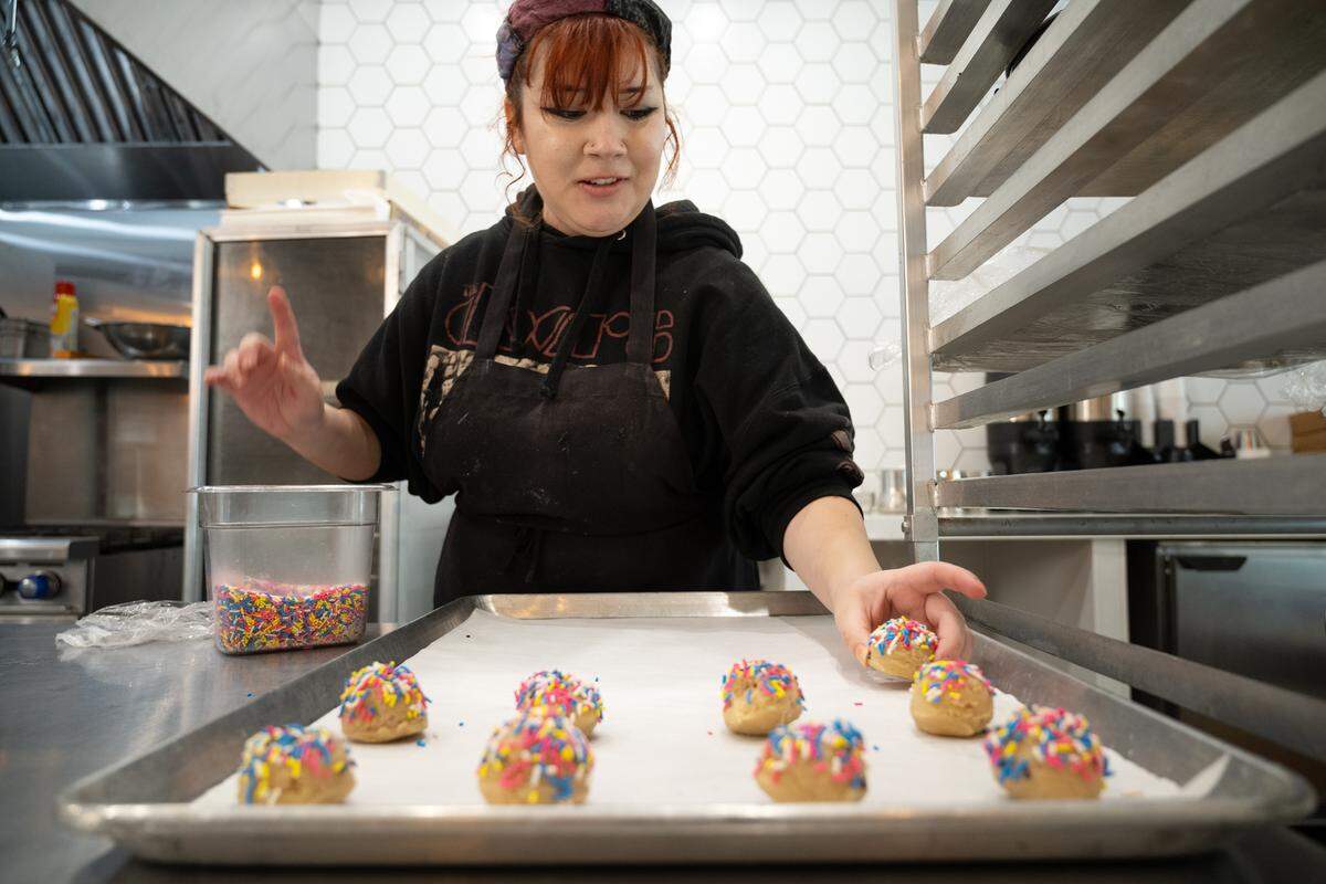 Tara Avila decorates cookie dough before baking at the Bakeshop in Modesto, Calif., Thursday, Oct. 12, 2023.