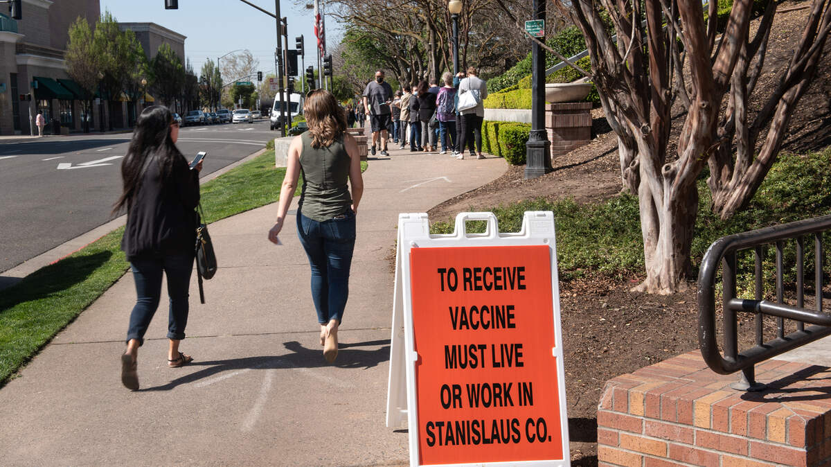 People line up at the COVID-19 vaccination clinic at Modesto Centre Plaza in Modesto, Calif., on Thursday, April 1, 2021.