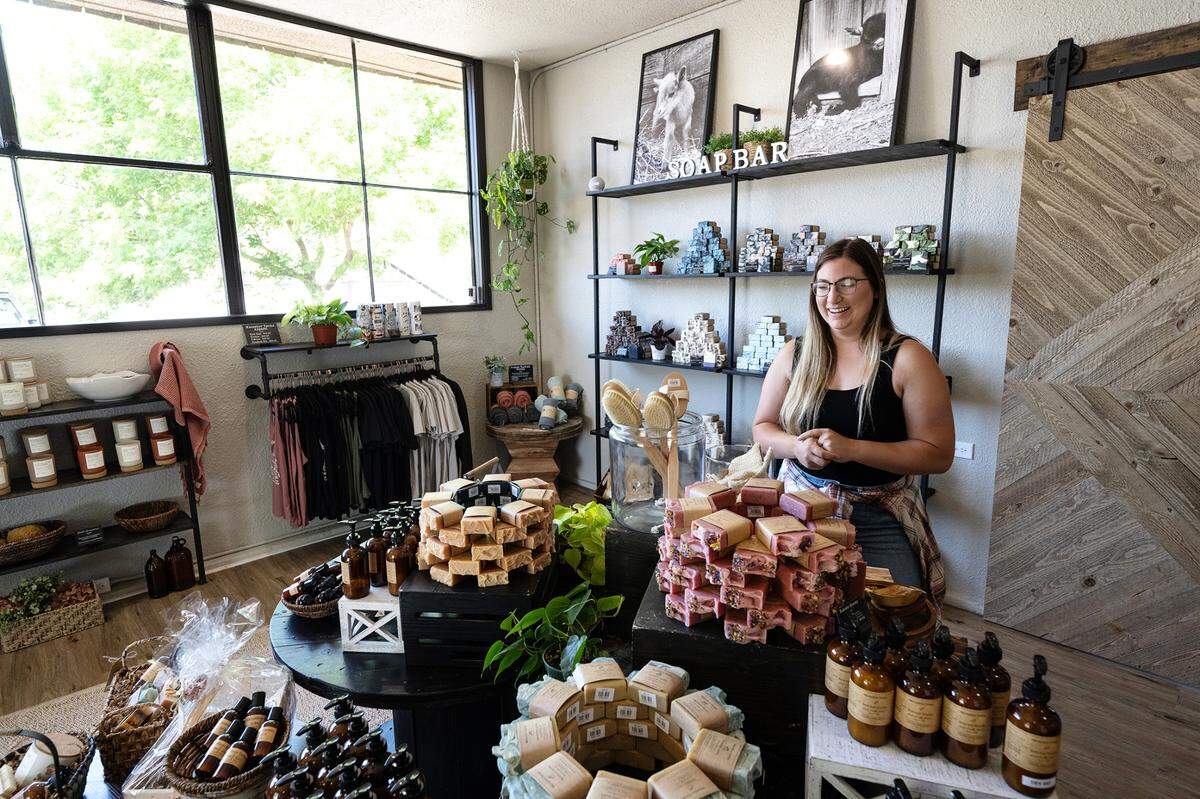 Owner Bethany Riner with her line of soap products at Mazzeltov Farms Soap in Waterford, Calif., Tuesday, May 16, 2023.