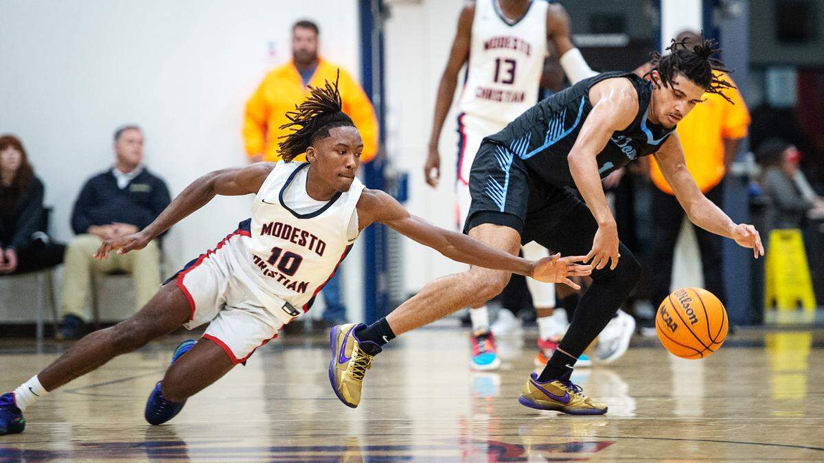 Modesto Christian’s BJ Davis (10) pressures Downey’s Lloyd French during the first-round game in the Modesto Christian Holiday Hoop Classic in Salida, Calif., Tuesday, Dec. 27, 2022. MC won the game 44-37.