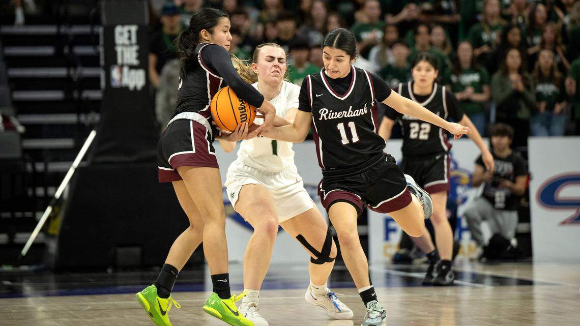 Riverbank’s Leilani Olanolan and teammate Aliyah Felix steal the ball from Liberty Ranch’s Kendall Duryee during the Sac-Joaquin Section D-4 championship game at the Golden 1 Center in Sacramento, Thursday, February, 27, 2025.