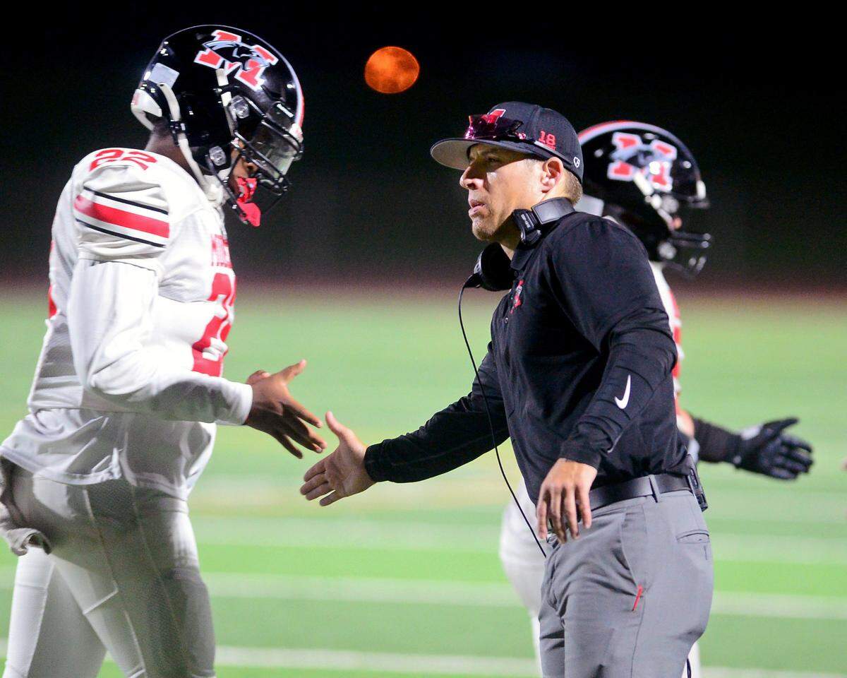 Modesto High Head Coach Dylan Miller greets his players after a touchdown during a game between Modesto High School and Central Valley High School at Gregori High School in Modesto, California on September 13, 2024.