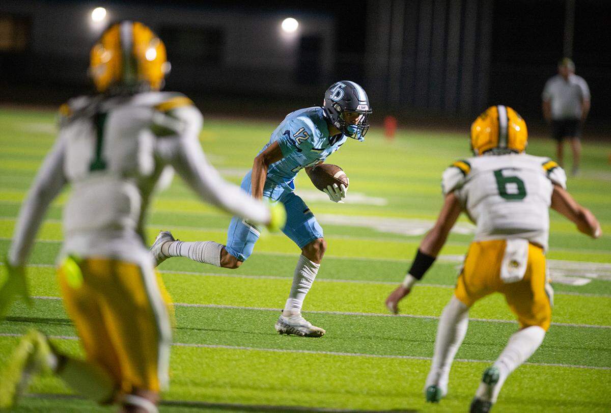 Downey’s Gabe Hernandez runs the ball during the nonleague game with Tracy at Downey High School in Modesto, Calif., on Friday, September 16, 2022.