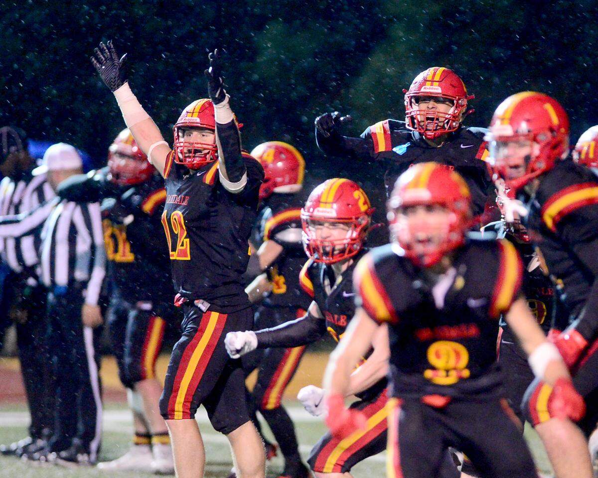 Oakdales Wes Burford (12) and the rest of the Oakdale defense celebrates a fourth down stop during a 2024 CIF Sac-Joaquin Section Division 3 playoff game between Oakdale High School and Destiny Christian Academy at Oakdale High School in Oakdale California on November 22, 2024. Oakdale won the game 49-35.