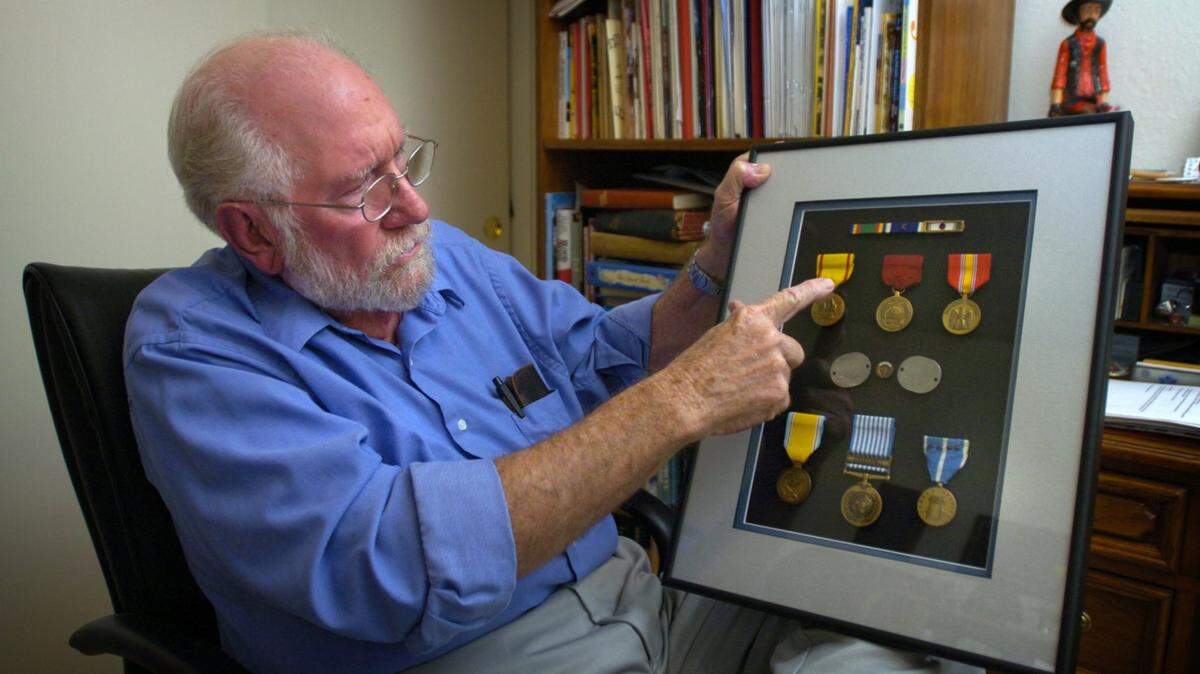 Korean Vet Al Menshew showing his medals from Korea at his Turlock home. Hoskins interviewing. (The Modesto Bee/ Bart Ah You)