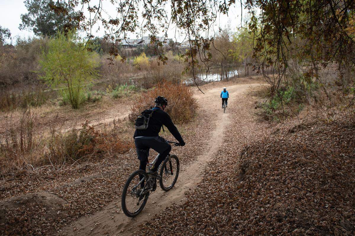 Bikers use the trail along the Tuolumne River in Modesto, Calif., Friday, Dec. 11, 2020.