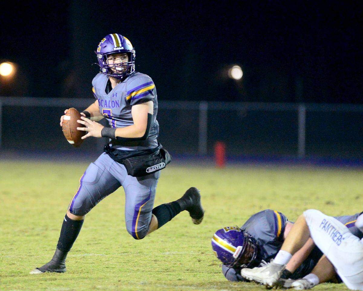 Escalon quarterback Donovan Rozevink (7) scrambles out of the pocket during a 2023 CIF San Joaquin Section Division IV football game between Escalon and West Park at Escalon High School in Escalon, California, on Nov. 17, 2023. Escalon won the game 48-28.