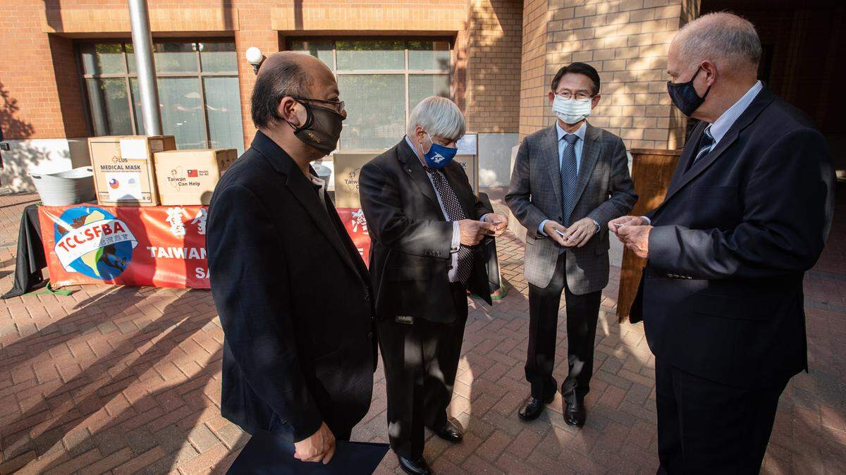 Modesto Mayor Ted Brandvold, right, and Stanislaus County supervisor Jim DeMartini, second from left, talk with The Taiwanese Chamber of Commerce San Francisco Bay Area president, Joe Chou, left, and Alex Y. H. Lee, deputy director general of the Taipei Economic and Cultural Office, second from the right, during a donation of 10,000 surgical masks to Stanislaus County in Modesto, Calif., on Thursday Oct. 15 2020. The Stanislaus Chinese Association helped facilitate the donation.