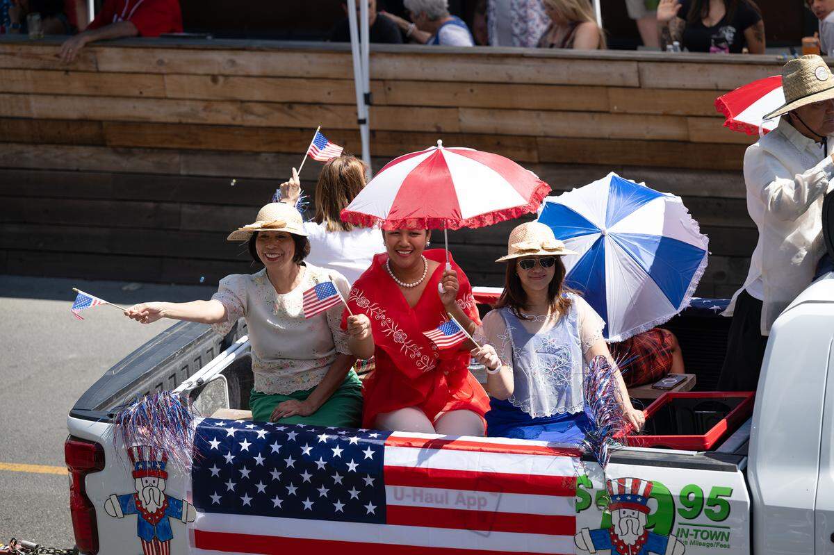 Filipino-American Association members wave to the crowd during the Independence Day Parade in Modesto, Calif., Tuesday, July 4, 2023.
