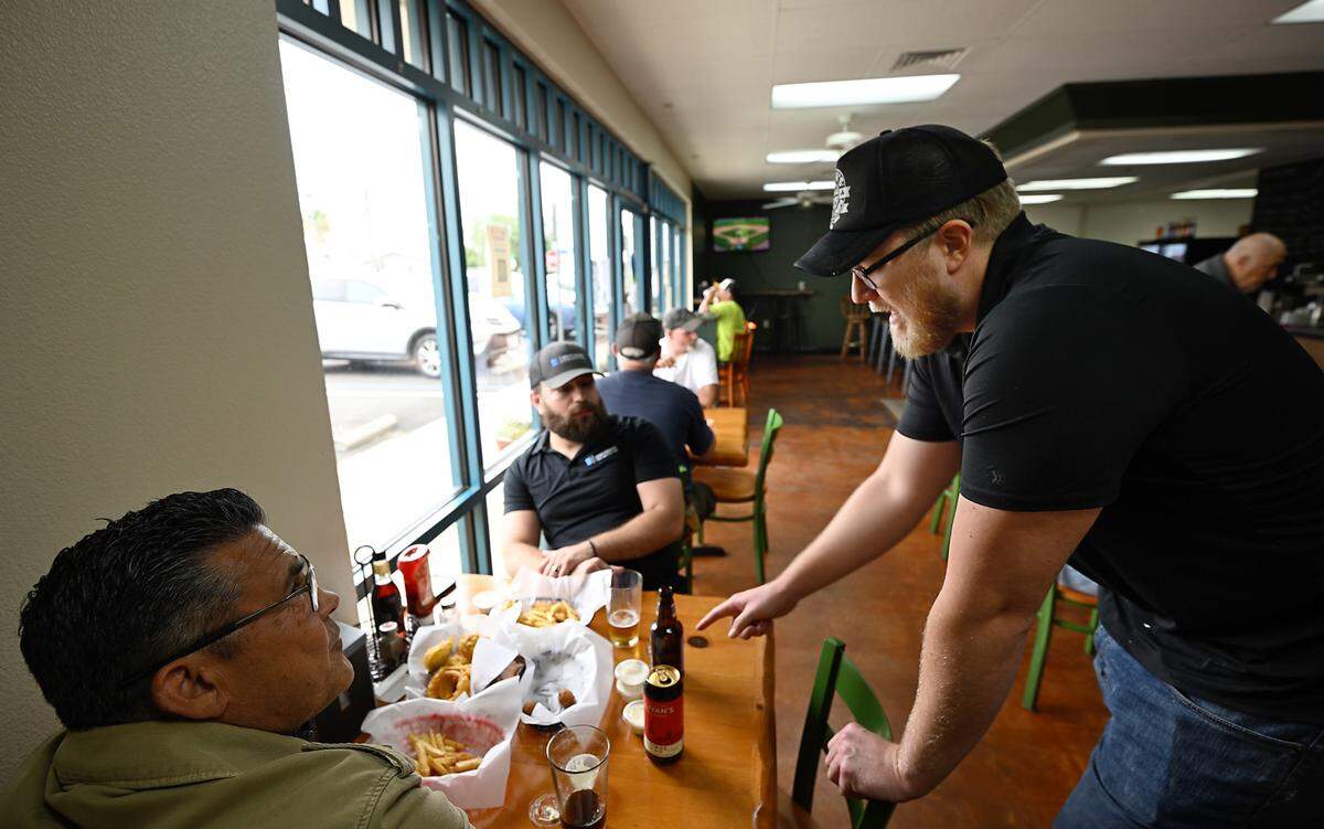 Owner Ryan Donnelly, right, talks with customers Sergio Carrera, left, and Evris Mazorra at Ann’s Fish & Chips in Hughson, Thursday, April 17, 2025.