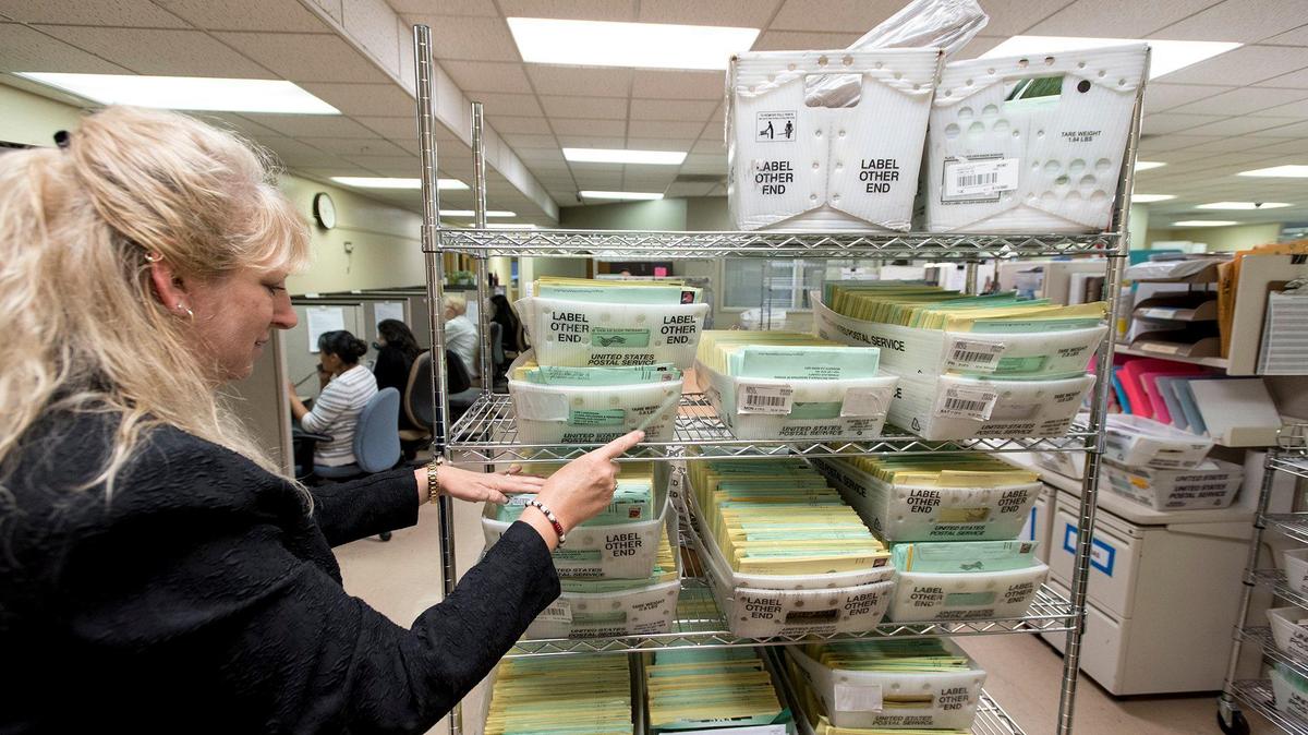 Stanislaus County Registrar of Voters Donna Linder points out the ballots that arrived at the Stanislaus County Registrar of Voters office on Monday in Modesto, Calif.