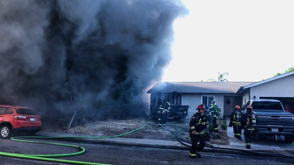 Turlock Firefighters work to extinguish a residential structure fire on Sunday, June 29, 2025.