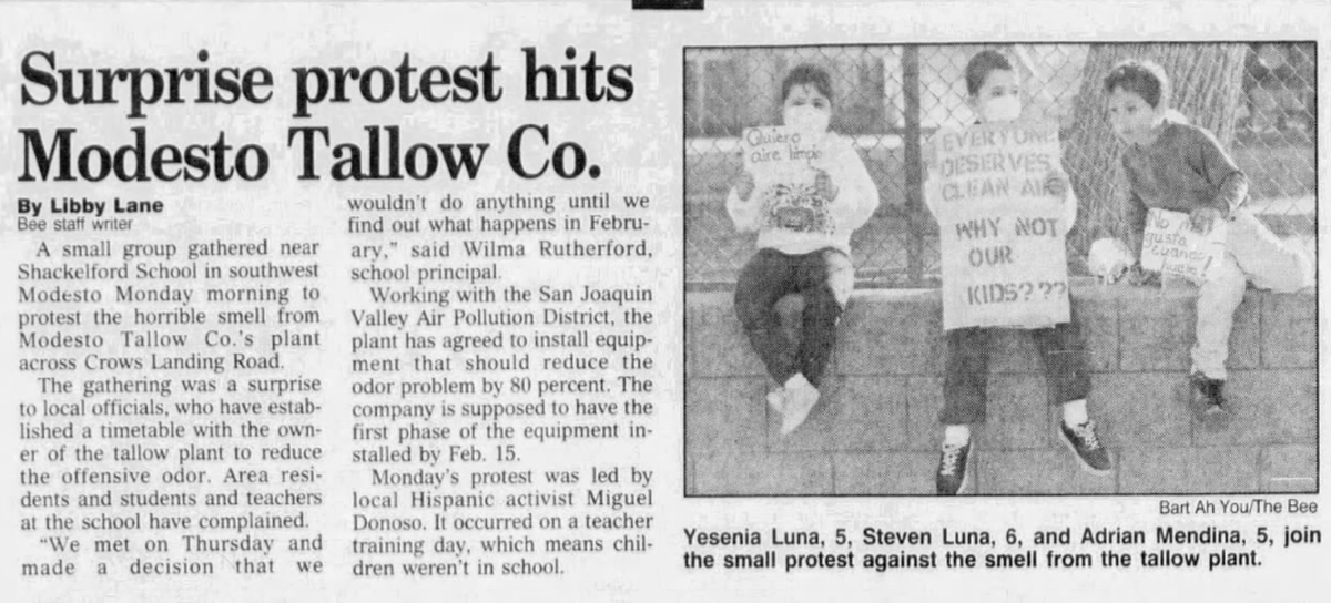 Three children sitting on a ledge holding signs, one reads: "Everyone deserves clean air, why not our kids?"