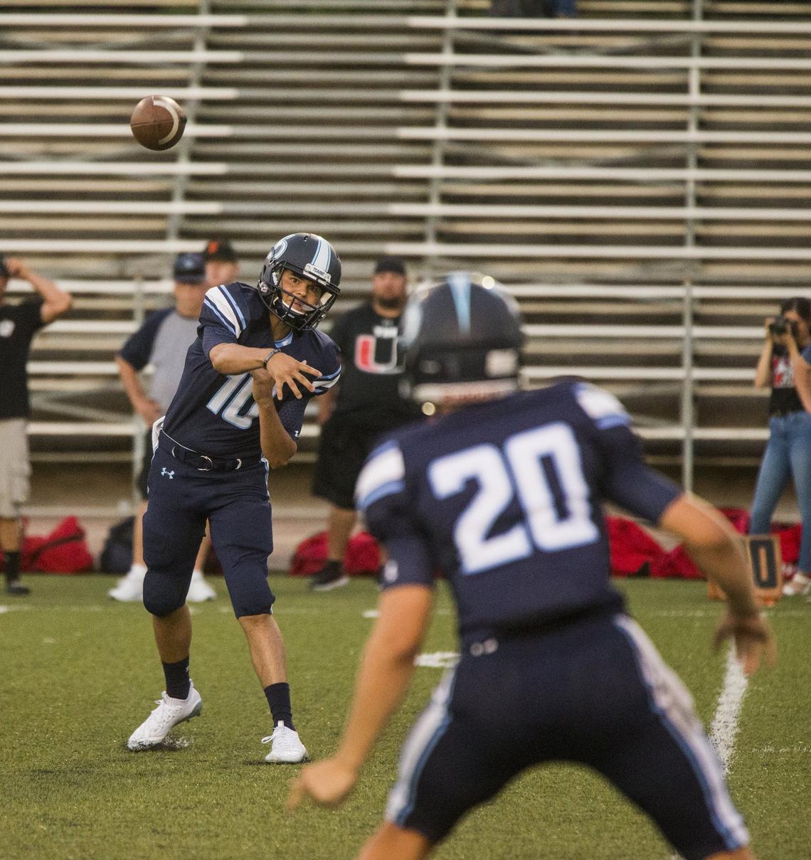 Downey Highs Bryce Gouker, 10, throws a pass to Beau Green, 20, as they looks to gain yards. Downey High took on East Union Friday Aug. 17, 2018.
