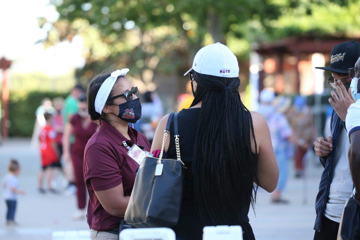 Modesto Nuts General Manager Veronica Hernandez talks with fans at John Thurman Field in Modesto, Calif.