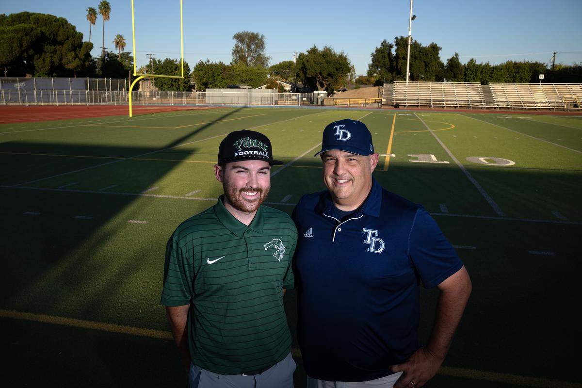 Father and son head coaches Jeremy Plaa (Downey), right, and Braden Plaa (Pitman) at Downey High School in Modesto, Tuesday, Oct. 7, 2025. The coaches face off Friday for the first time.