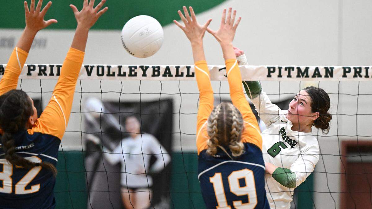 Pitman’s Maryn Hall spikes the ball into Oak Ridge defenders Lizi Horning (32) and Avery Towne (19) during the non-league match at Pitman High School in Turlock, Calif., Thursday, September 7, 2023. Oak Ridge won the match 3-2.