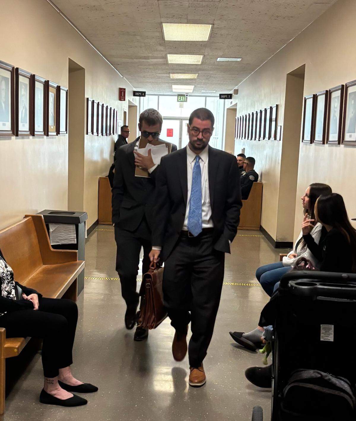 Matthew Paez, left, walks behind his attorney Ryan Stivers in the hallway outside Department 4 of Stanislaus County Superior Court following an early case management hearing on Friday, July 25, 2025.