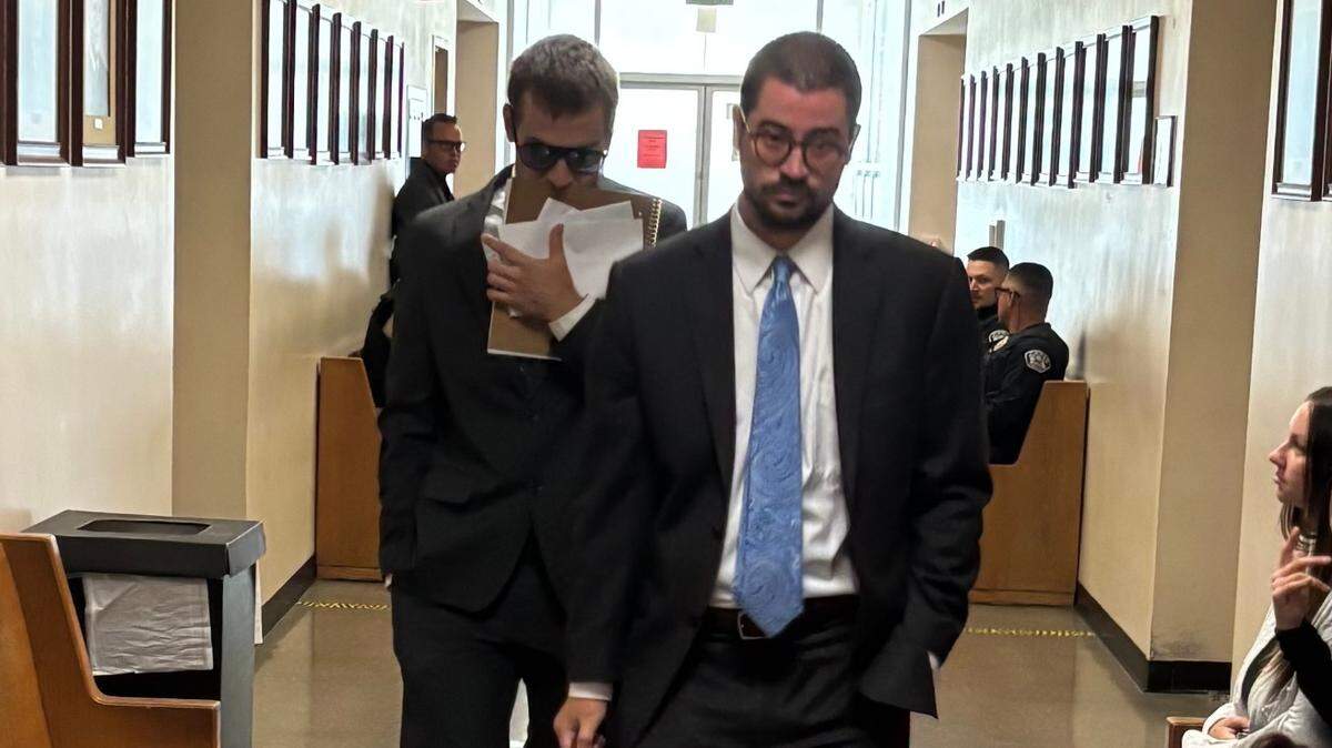 Matthew Paez, left, walks behind his attorney Ryan Stivers in the hallway outside Department 4 of Stanislaus County Superior Court following an early case management hearing on Friday, July 25, 2025.