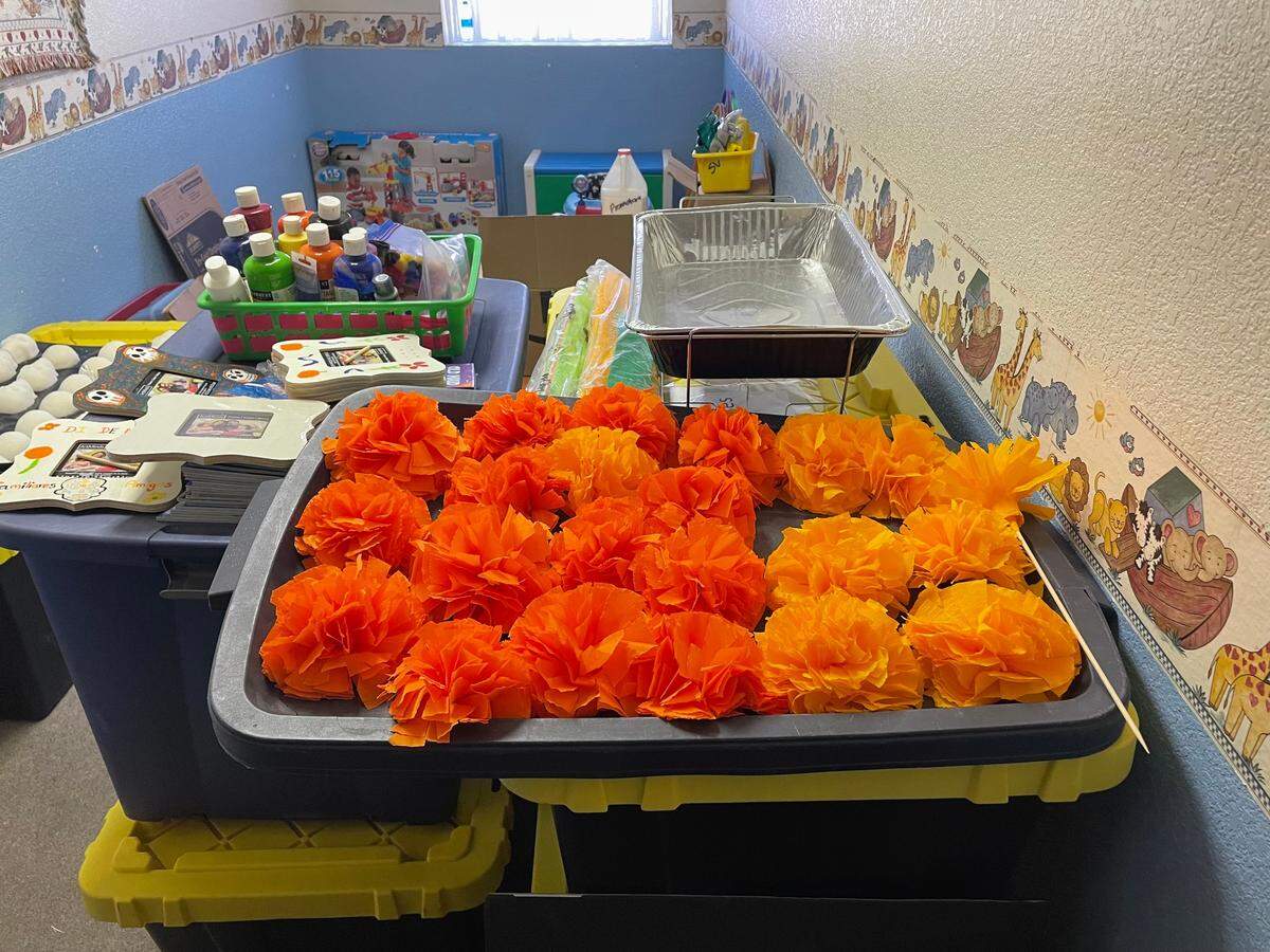 Cempasúchil, marigold flowers, are used in Day of the Dead celebrations to attract souls to an altar and to bring joy. As women in South Modesto decorate the flowers, they bond over shared mental health challenges.